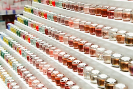 Rows of cosmetics on a retail display shelf
